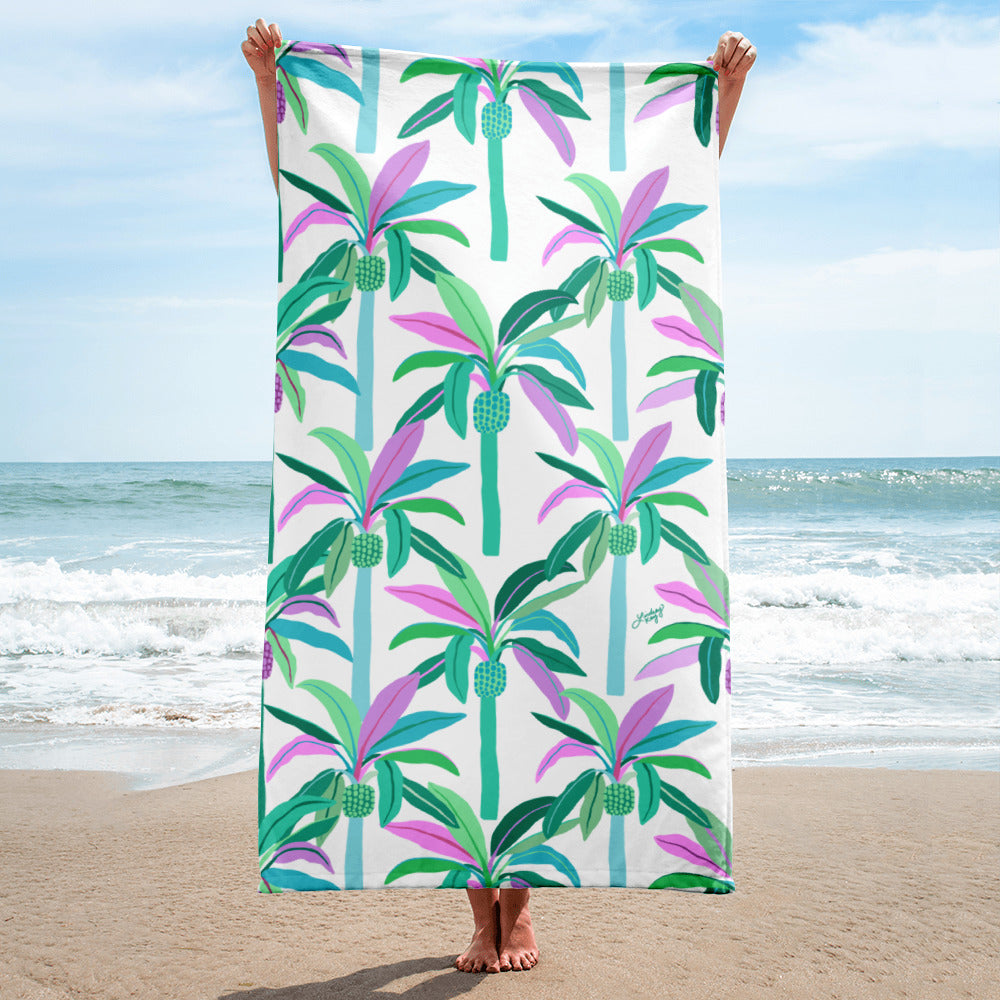 Colorful tropical palm tree beach towel with green, teal, and purple hand-drawn design by Lindsey Kay Collective – fun summer beach accessory